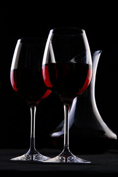 a two wine glasses on black