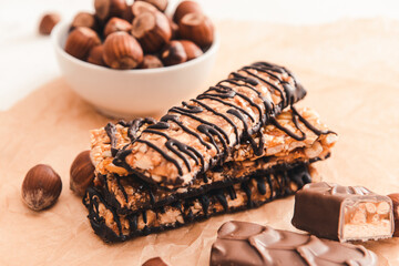 Tasty chocolate nut bars on parchment