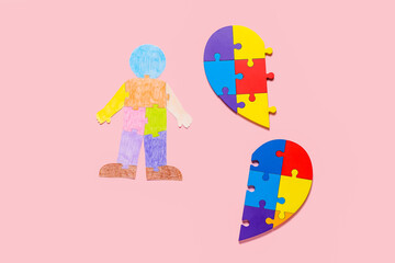 Colorful puzzle pieces and human figure on color background. Concept of autistic disorder