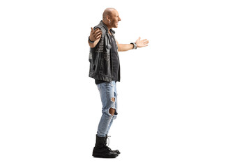Full length profile shot of a punk standing with arms wide open