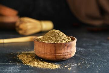 Bowl with hojicha powder on black background