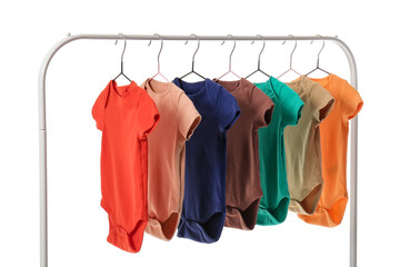 Rack with different baby bodysuits on white background