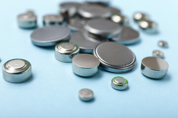 Lithium button cell batteries on blue background, closeup