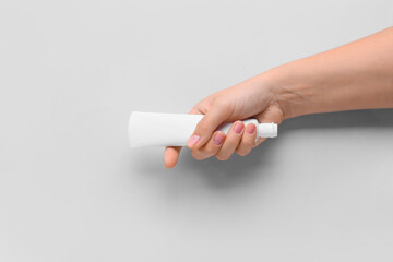 Female hand with tooth paste on white background