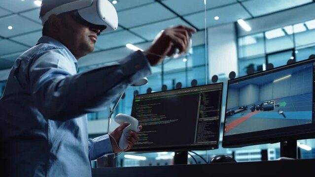 Industrial Software Developer Writing Code and Testing Automotive Manufacturing Interface. Engineer Editing Electric Motor and Car Chassis while Wearing Virtual Reality Headset and Using Controllers.