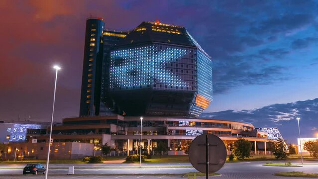 Minsk, Belarus. Day To Night Time Lapse Time-lapse Transition National Library Building In Summer Evening Sunset Time. Evening Night Scenic View Of Famous Landmark. Hyperlapse, Motion
