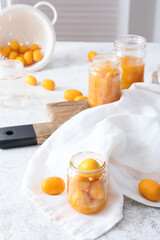 Jar with fresh kumquat fruits on kitchen table