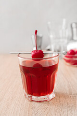 Glass of tasty Manhattan cocktail on wooden table, closeup