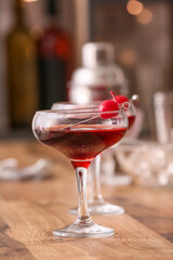 Glass of tasty Manhattan cocktail on wooden table, closeup