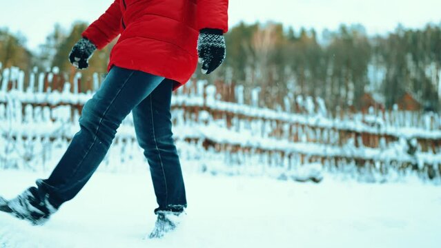 girls feet walk on the snow on the background snow-covered forest winter cold.