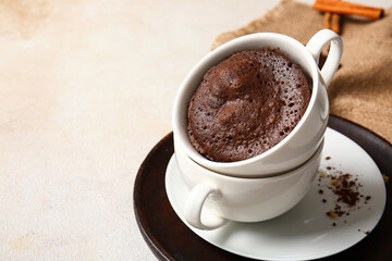 Cups with tasty chocolate brownie on light background