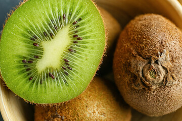 Fresh juicy kiwi in bowl, closeup