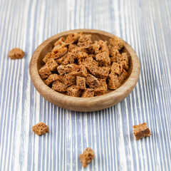 Fried crackers on a wooden saucer.