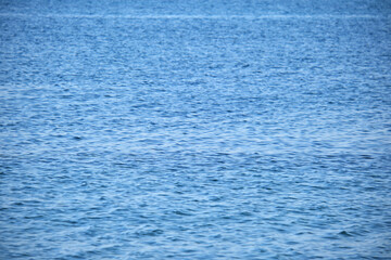 Closeup seascape surface of blue sea water with small ripple waves