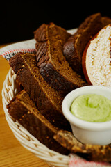 Bavarian bread basket with white, black bread, pretzel and sauce