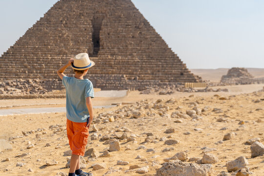 Boy walking in front of the pyramid of Mikerin on the Giza plateau