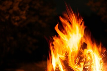 Fototapeta premium Bright glowing outdoor campfire in fall