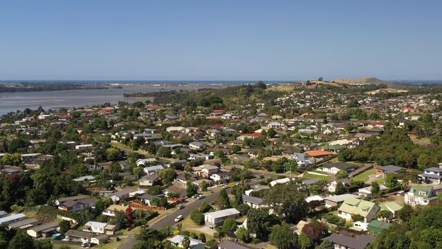 Drone shot of an unrecognizable modern suburb somewhere in the new world. Sunny summer. Sea in distance.. Tauranga, New Zealand