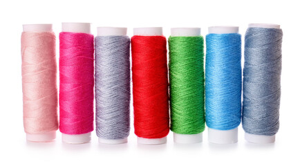 Different sewing thread spools on white background