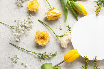 Composition made of beautiful flowers and blank card on light background