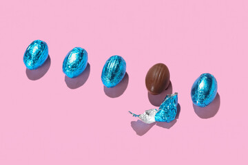Chocolate Easter eggs on pink background