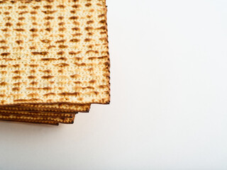 Traditional Jewish matzah bread on a white background. Jewish Passover, traditional holiday treat, kosher food. There is an empty space to insert. Advertising, invitation.