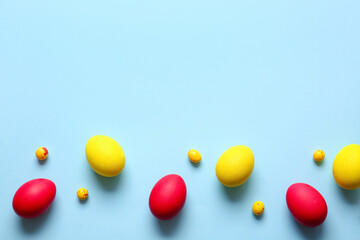 Red and yellow Easter eggs on color background