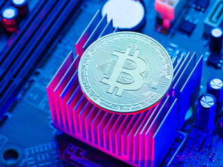The most popular cryptocurrency is bitcoin on personal computer components. Blue neon lighting....