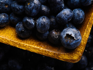 Macro photography of fresh blueberries in a yellow square bowl. Vitamins, antioxidants. Culinary - breakfasts, juices, fresh juices, ingredients for dishes. The medicine. Restaurant, hotel.
