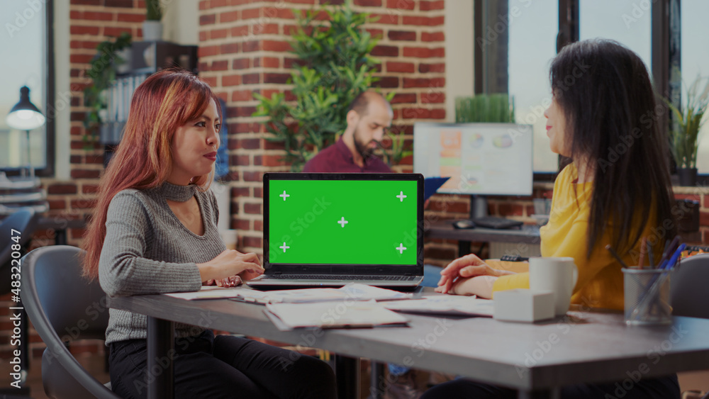 Poster business people looking at laptop with green screen and working to develop partnership. coworkers us