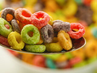 macro photography. Multicolored fruit cereal snacks in a bowl. Beautiful composition. Fast food breakfasts. Traditional American breakfast, children's. diet food. Wallpaper, background, texture.