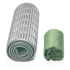 rolled up polyurethane mat and folded air mattress for camping and tourism isolated on white background