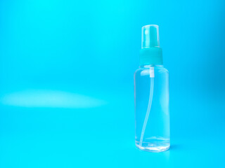 Sinitized spray bottle on a blue background with copy space.