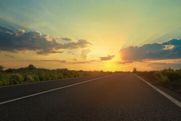 View of empty asphalt road at sunset