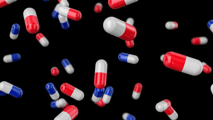 Medical capsules red-white and white-blue falling on a black background.