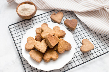 homemade heart-shaped cookies cool on the grill, valentine's day gift with love, gluten-free buckwheat flour pastries.