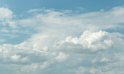 Cumuliform cloudscape on sky. Panorama. The sun is hidden.  Cumulonimbus clouds.