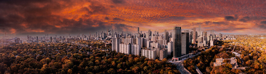 Drone Panorama of Toronto skyline with trees surrounding the cityscape	 sun set time 