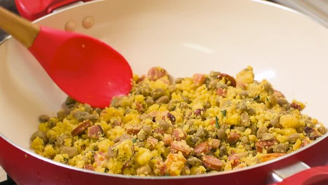 Northeastern Feijao Tropeiro, brazilian dish made with cuscuz, string bean, sausage, bacon, chive and curd cheese. 