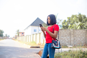 african woman ordering taxi, cab using smart phone app,