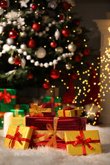 Fototapeta na wymiar Beautiful gift boxes near Christmas tree in room