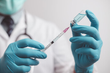 doctor or scientist in the COVID-19 medical vaccine research and development laboratory holds a syringe with a liquid vaccine to study and analyze antibody samples for the patient.
 - obrazy, fototapety, plakaty