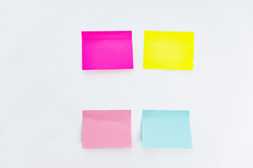 Colored notes to remind you of your thoughts or ideas on a white background. four colored stickers on a white background.
