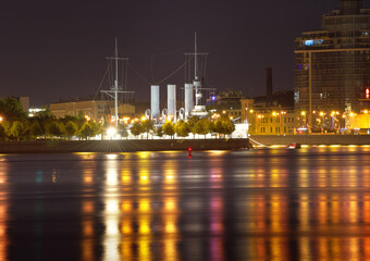 Fototapeta na wymiar View of the cruiser Aurora at the Petrogradskaya embankment in the night