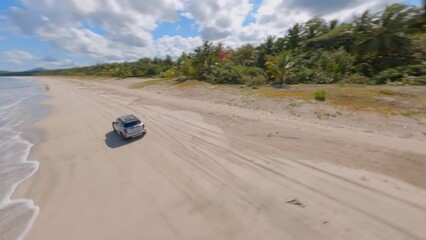 Dynamic fpv shot at miches town beach in sunny day, turquoise blue water