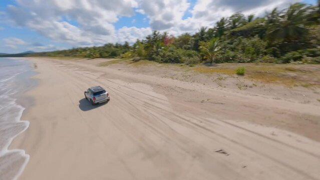 Dynamic fpv shot at miches town beach in sunny day, turquoise blue water