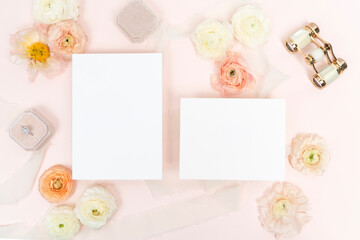 Floral flat lay with blank bridal stationery invitation cards and velvet ring box