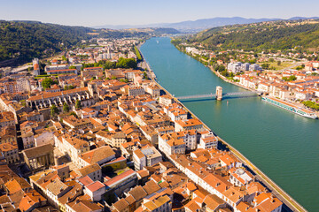 General view of Vienne city on banks of Rhone river surrounded by high hills in sunny summer day, Isere, France - obrazy, fototapety, plakaty