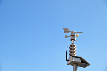 The Anemometer (Wind Speed Meter) with blue sky background - energy conservation concept from...