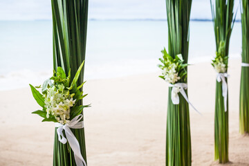 Floral arrangement at a wedding ceremony on beach.